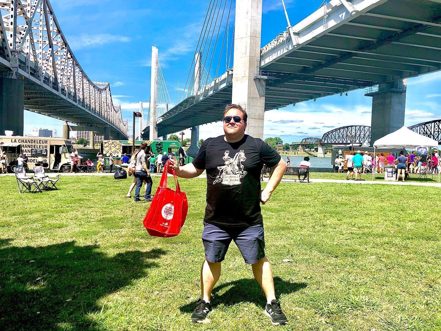 person posing under bridge